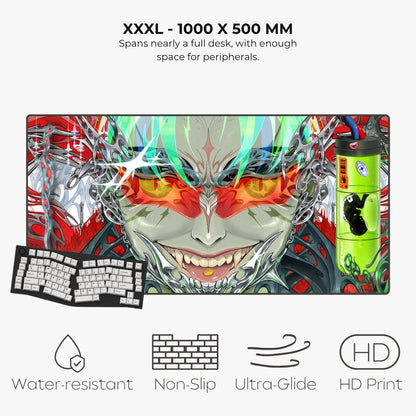 A large gaming desk mat with a detailed anime-style monster face graphic, shown on a light gray background with text describing its 1000 x 500 mm size and feature icons for water resistance, non-slip, ultra glide, and HD print. A keyboard and a green mouse are also pictured as styling props.