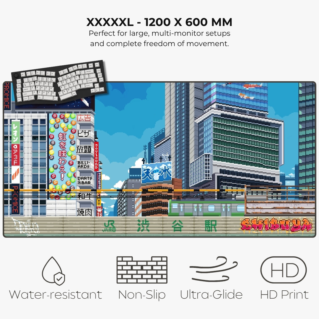 A large rectangular gaming mat featuring a colorful pixel-art cityscape with Japanese signage and the text 'Shinjuku' at the bottom. The image includes marketing text at the top ('XXXXXL - 1200 X 600 MM') and feature icons at the bottom for water-resistant, non-slip, ultra-glide, and HD print.