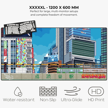 A large rectangular gaming mat featuring a colorful pixel-art cityscape with Japanese signage and the text 'Shinjuku' at the bottom. The image includes marketing text at the top ('XXXXXL - 1200 X 600 MM') and feature icons at the bottom for water-resistant, non-slip, ultra-glide, and HD print.