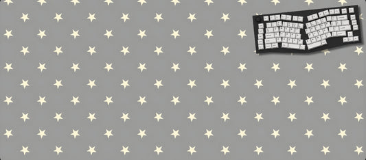 Gray desk mat with star pattern and a keyboard on a black background