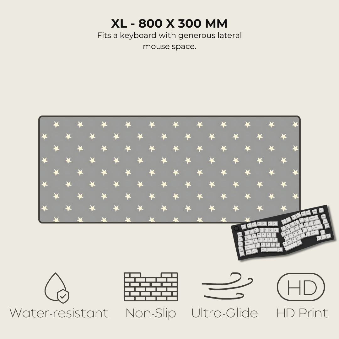 Gray mouse pad with star pattern and keyboard on a light gray background