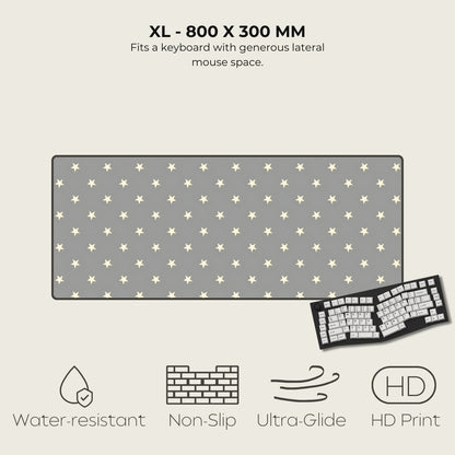 Gray mouse pad with star pattern and keyboard on a light gray background