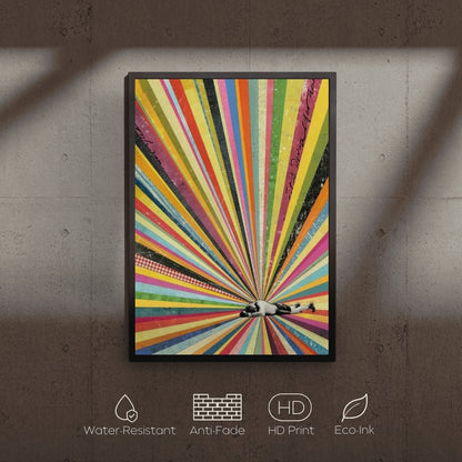 Colorful abstract art print with a black frame on a textured wall.