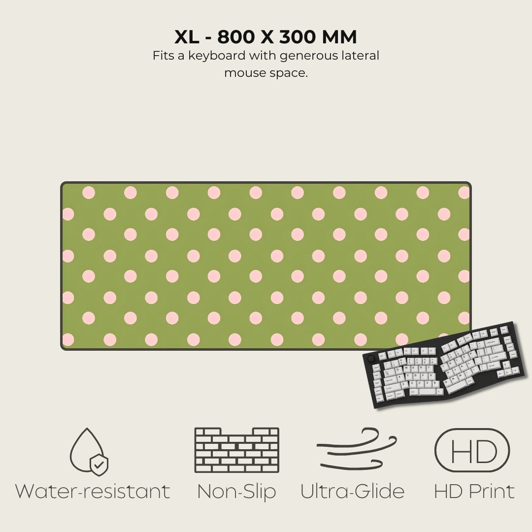 Green mouse pad with pink polka dots and keyboard illustration on a beige background