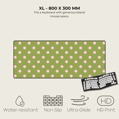 Green mouse pad with pink polka dots and keyboard illustration on a beige background