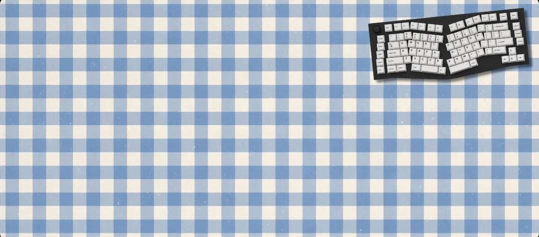 Blue and white checkered mouse pad with a keyboard graphic on a black background