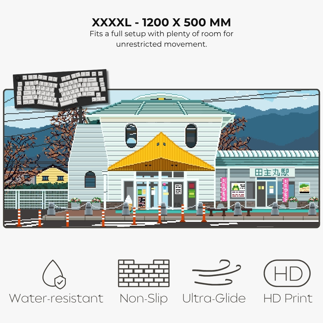 A product listing graphic for a XXXXL size art print or mural showing a stylized pixel-art scene of a Japanese station and surrounding buildings. Text at the top reads 'XXXXL - 1200 X 500 MM' with fit description, and icons at the bottom highlight water-resistant, non-slip, ultra-glide, and HD print qualities.