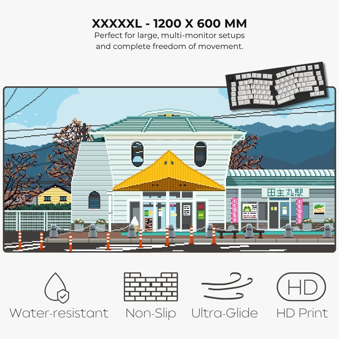 A promotional graphic for a large landscape art print showing a pixel-art style Japanese station building scene. Text at the top reads 'XXXXXL - 1200 X 600 MM' with additional product claims, and icons at the bottom mention water-resistant, non-slip, ultra-glide, and HD print qualities.