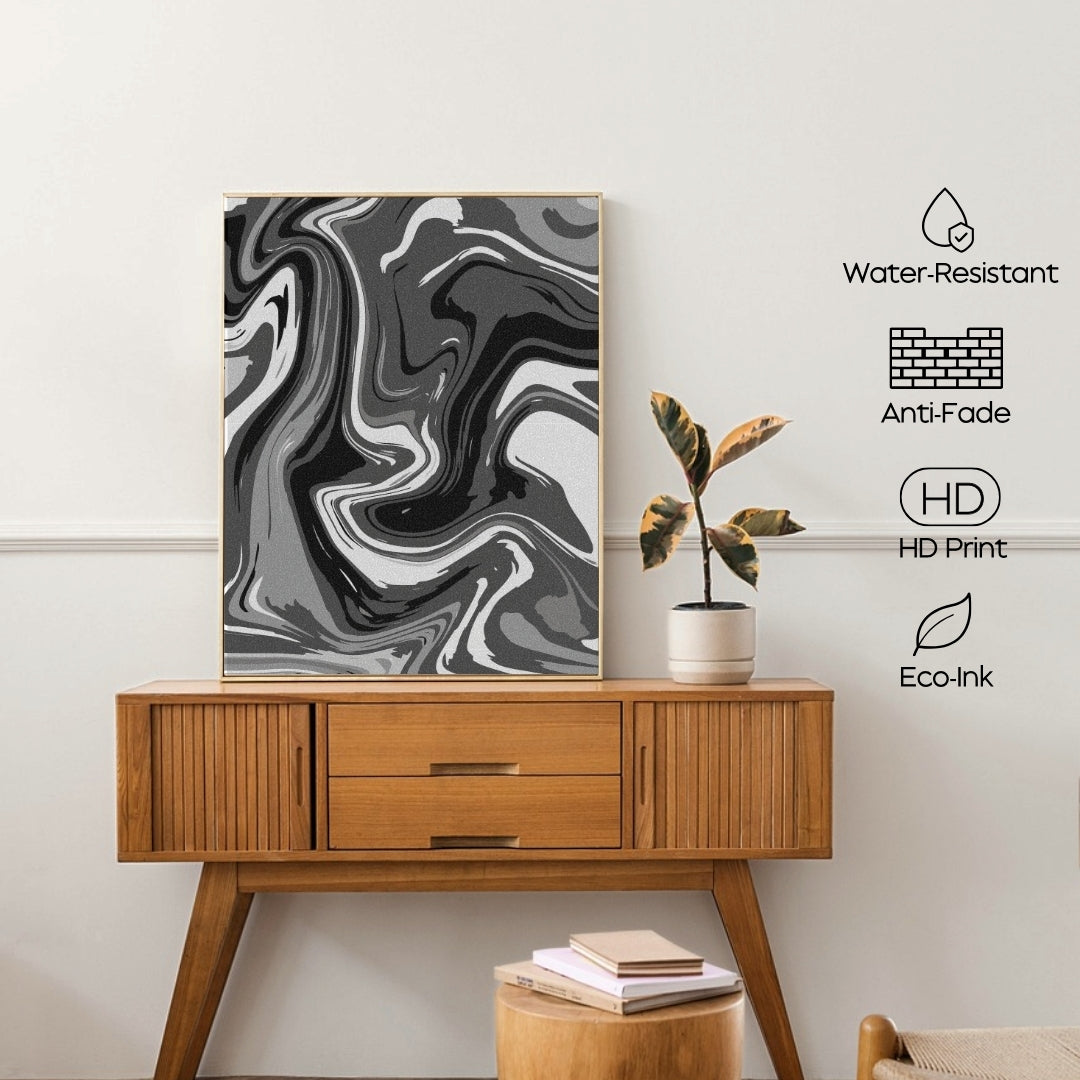 Wooden console table with a marble-patterned art print and a plant on a white wall.