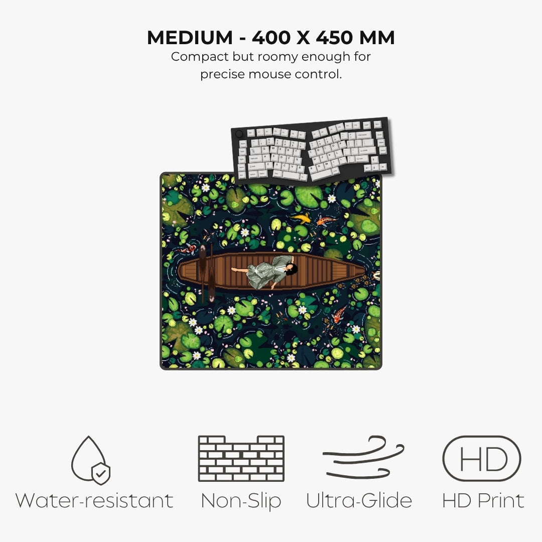 A product listing graphic for a medium-sized gaming mouse pad with a detailed pond and frog illustration. The pad features a dark background with green lily pads, white flowers, orange koi fish, and a brown wooden boat with a gray frog.
