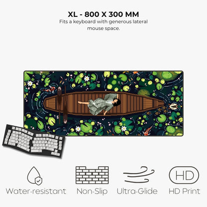 An XL keyboard mat with a detailed illustration of a woman in a boat on a pond, shown with a keyboard prop and text highlighting its features: 800 x 300 mm size, water-resistant, non-slip, ultra-glide, and HD print.