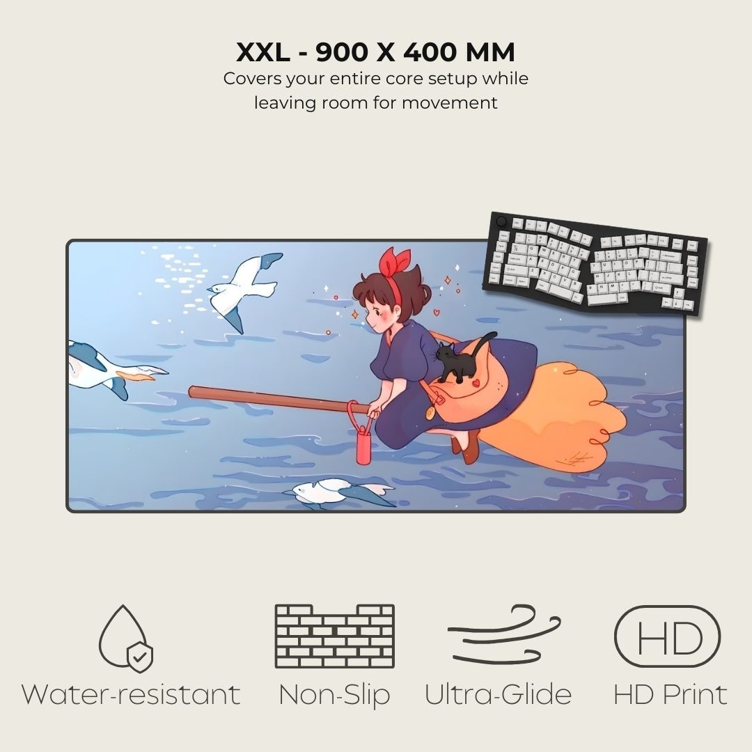 Large mouse pad with cartoon design of a character on a broomstick, keyboard, and text about size and features.