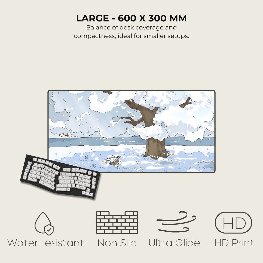 Large desk mat with winter design, keyboard, and feature icons on a light background