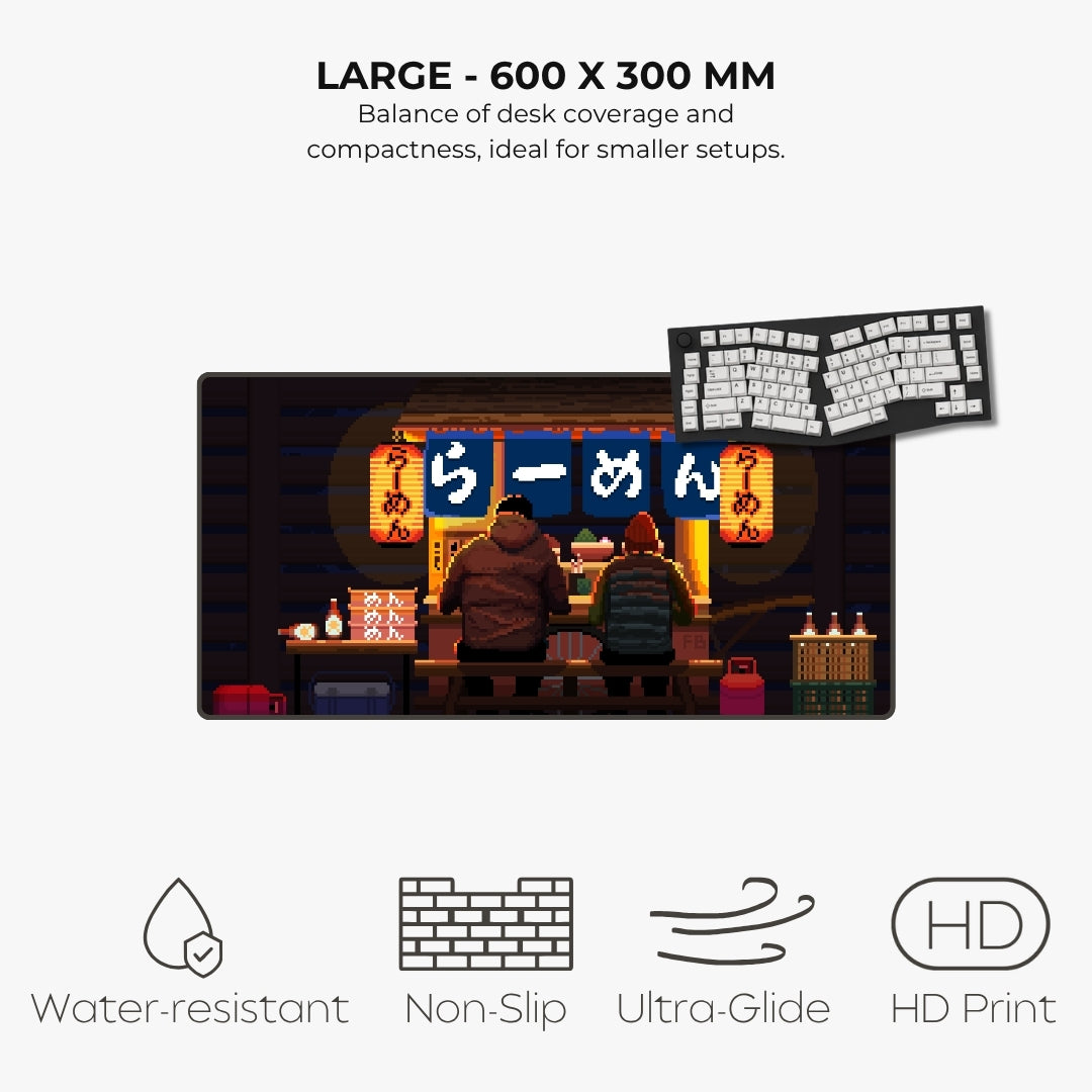 A large rectangular desk mat featuring a pixel-art ramen shop scene with two people sitting at a table under glowing orange and blue signs. The image includes marketing text reading 'LARGE - 600 X 300 MM' and feature icons for water resistance, non-slip texture, ultra-glide edge, and HD print.
