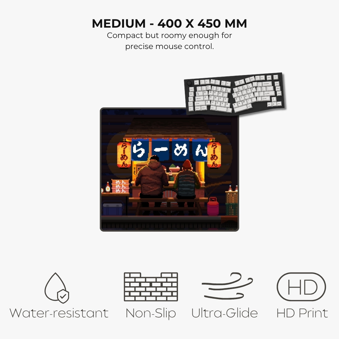 A product listing graphic for a medium-sized desk mat or mouse pad. The central product shows a colorful anime-style illustration of two people sitting at a table in a dimly lit restaurant, with a smaller inset showing the keyboard layout printed on the product.