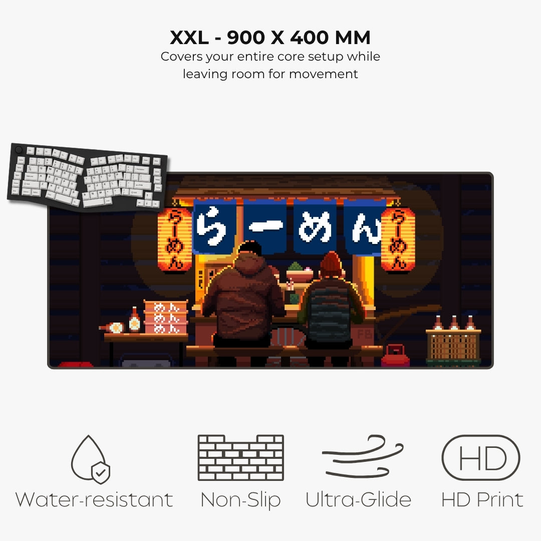 A XXL size desk mat featuring a pixel art illustration of two characters sitting at a ramen shop counter, shown on a light gray background with text highlighting its 900 x 400 mm size and features like water resistance, non-slip, ultra-glide, and HD print.